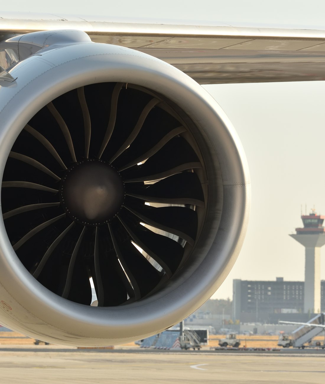 Close-up of a commercial aircraft turbofan engine on the tarmac